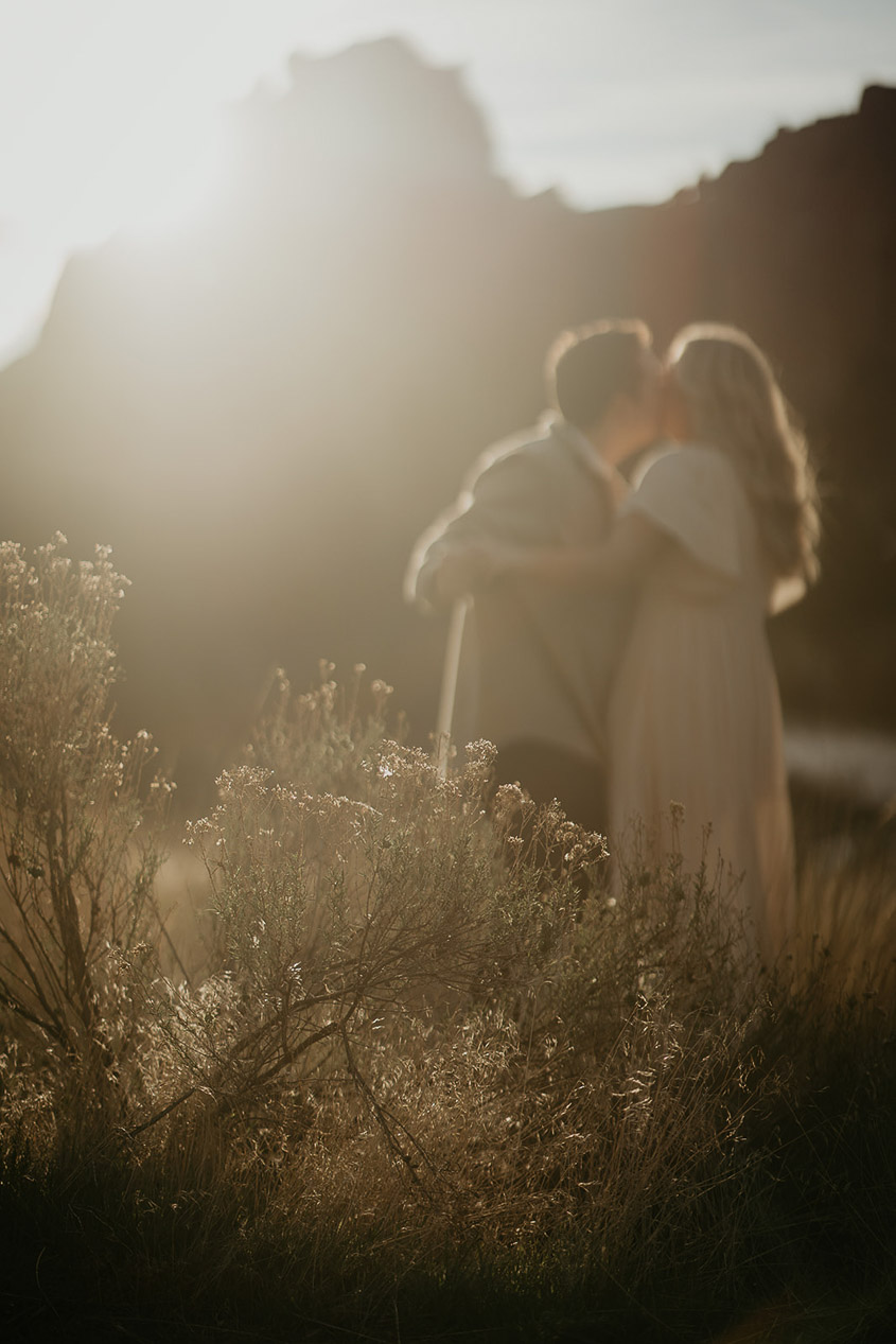 a couple kissing at sunset during their Smith Rock engagement session. 