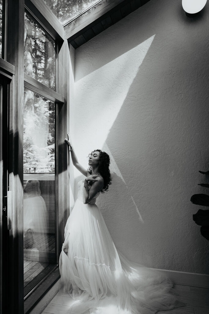 The bride posing by a window at The Woodlands house venue. 