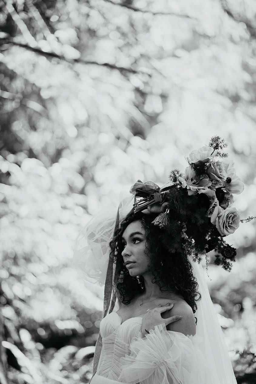 the bride posing, holding a bouquet of flowers above her head. 