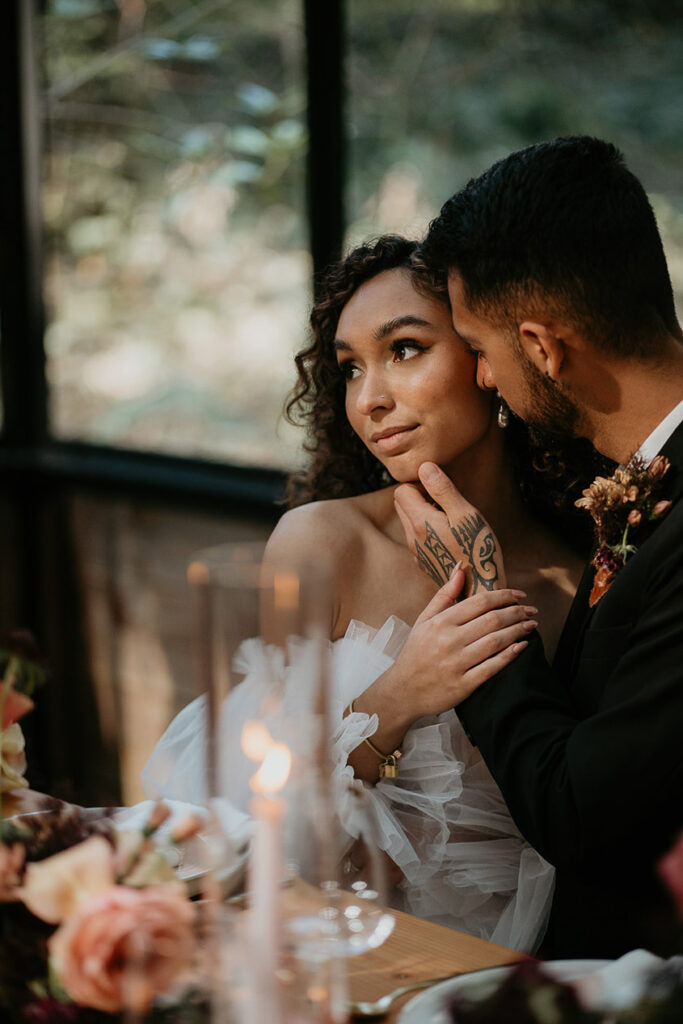 The bride and groom holding each other inside the greenhouse at The Woodlands House venue. 