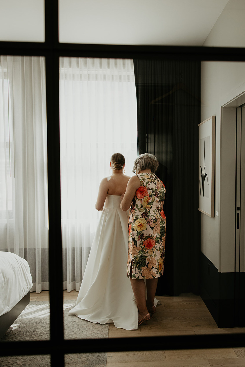 the bride putting on her wedding dress. 