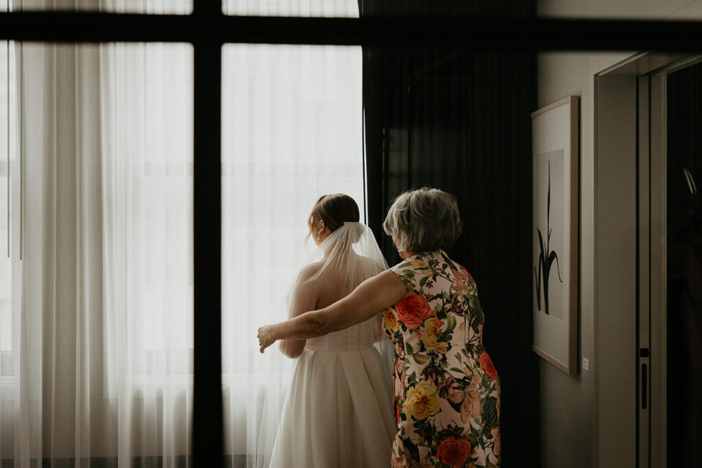 the bride getting her veil put on. 