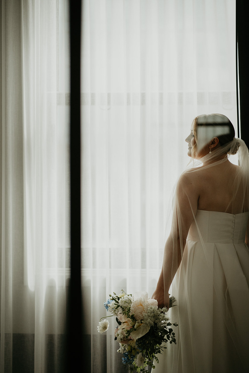 the bride posing with her bouquet. 