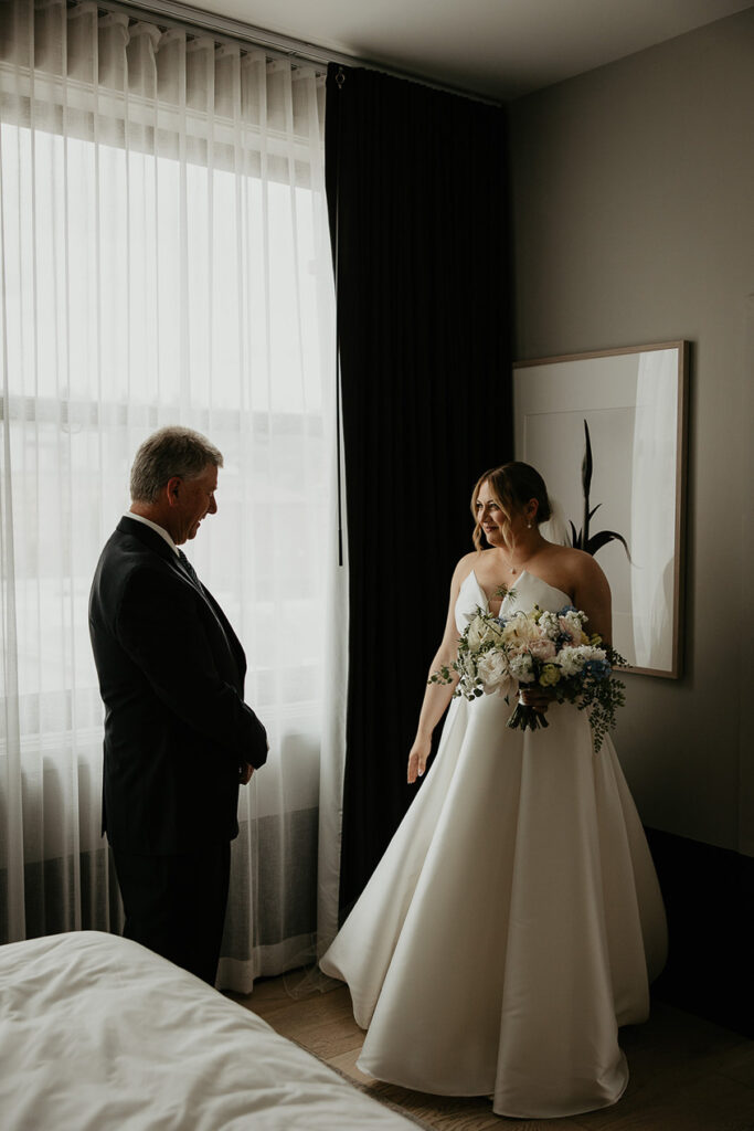 the bride and her father standing with each other. 