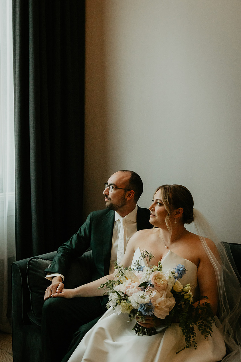 the bride and groom sitting with each other. 