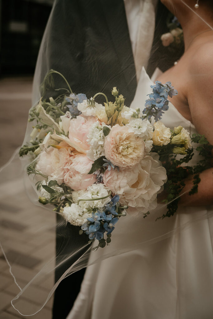 the bride's bouquet covered by her veil. 