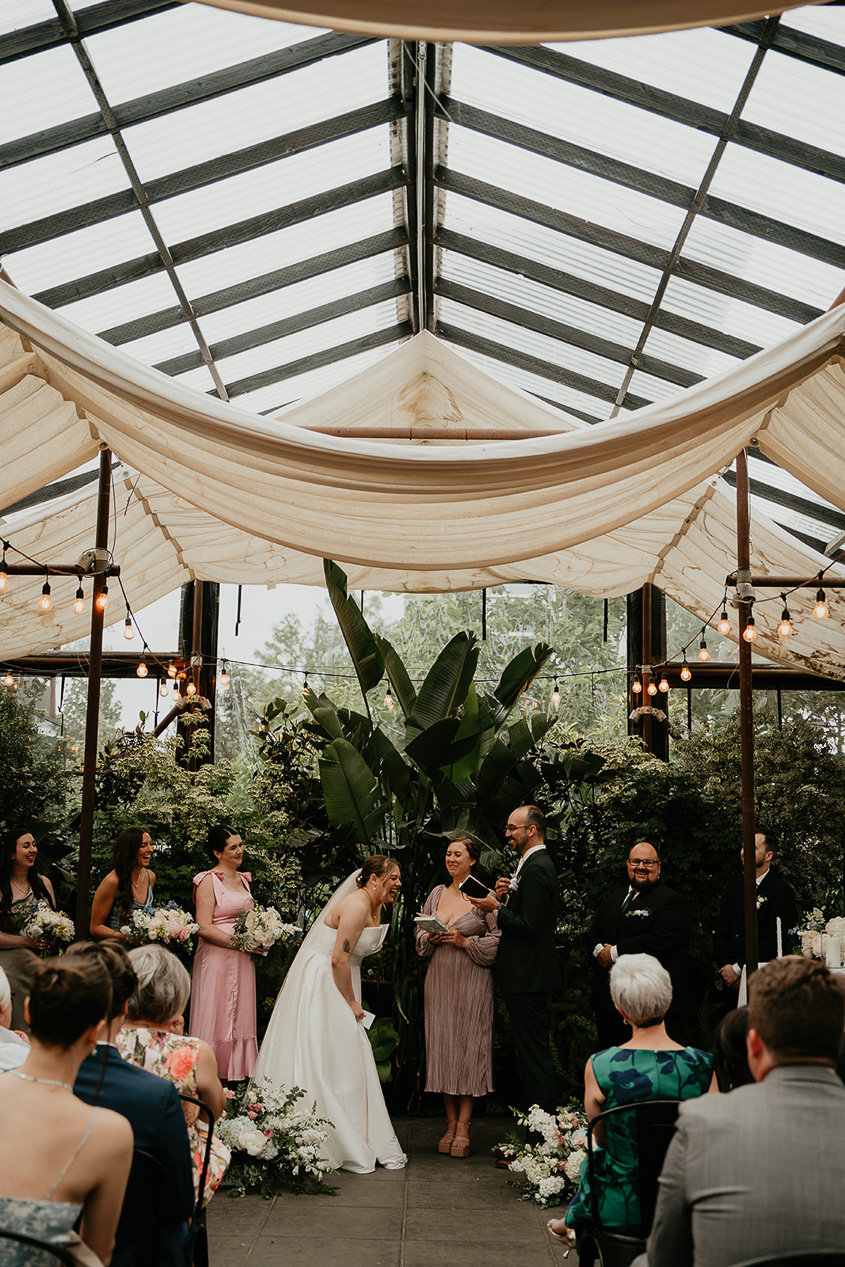 the bride laughing during her Blockhouse PDX wedding ceremony. 