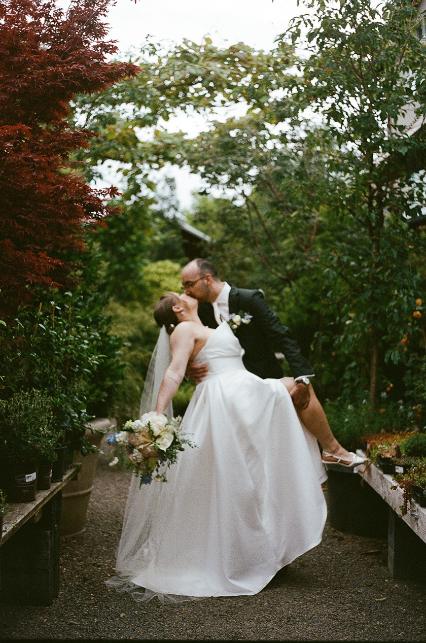 the bride and groom kissing in the nursery during their Blockhouse PDX wedding. 