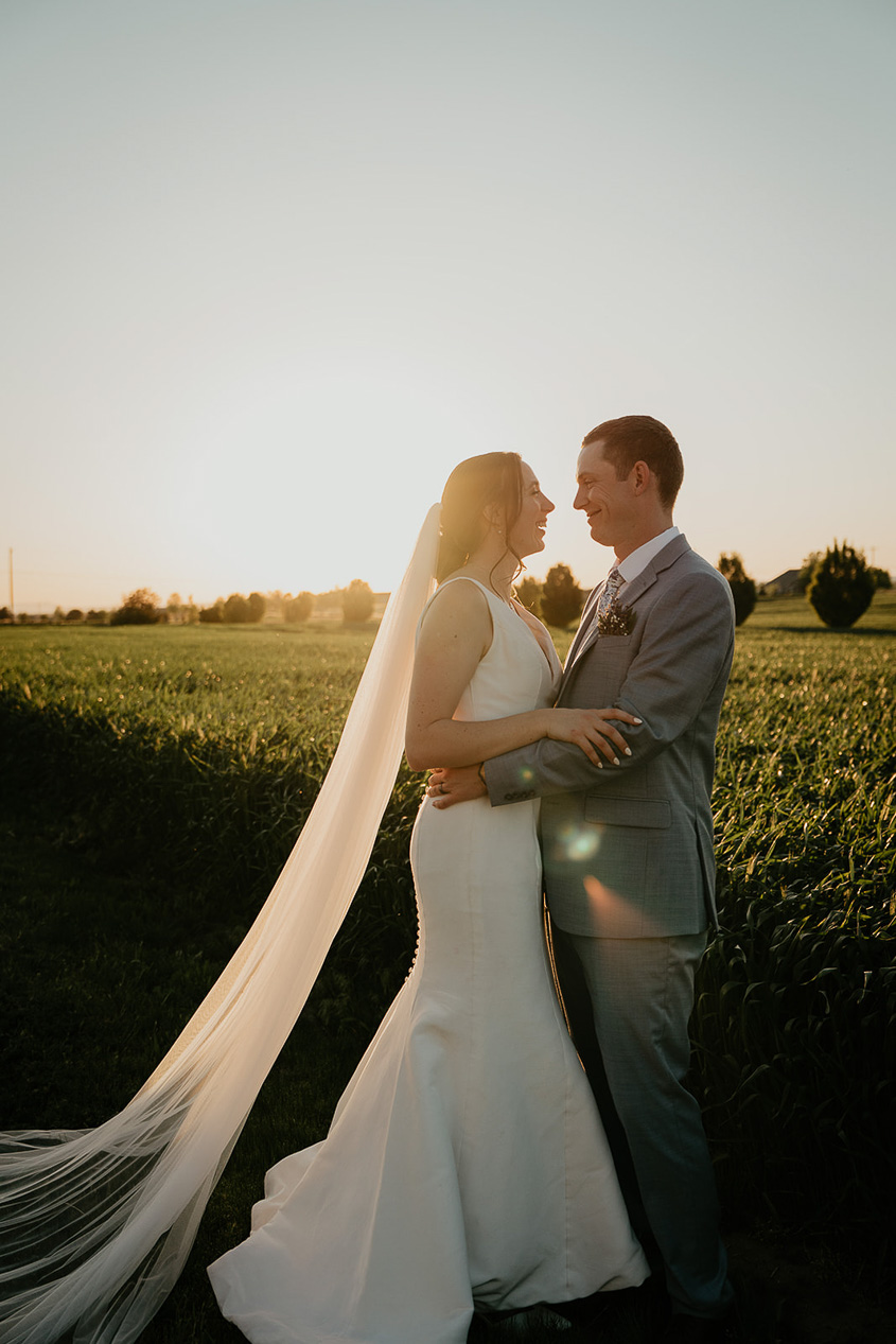 the bride and groom holding each other at sunset at Dusted Valley. 