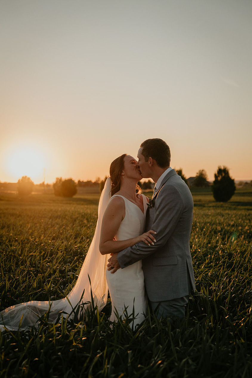 the newlyweds kissing at sunset at Dusted Valley. 