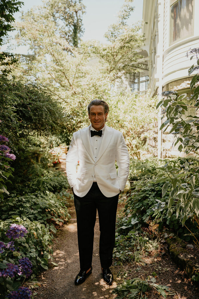 the groom posing in one of the gardens at Deepwood Museum and Gardens. 