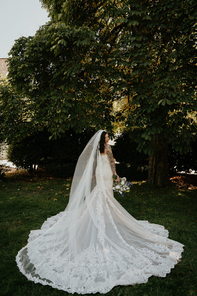 the bride showing off her dress and veil. 