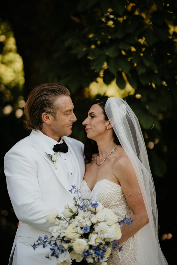 the bride and groom embracing each other. 