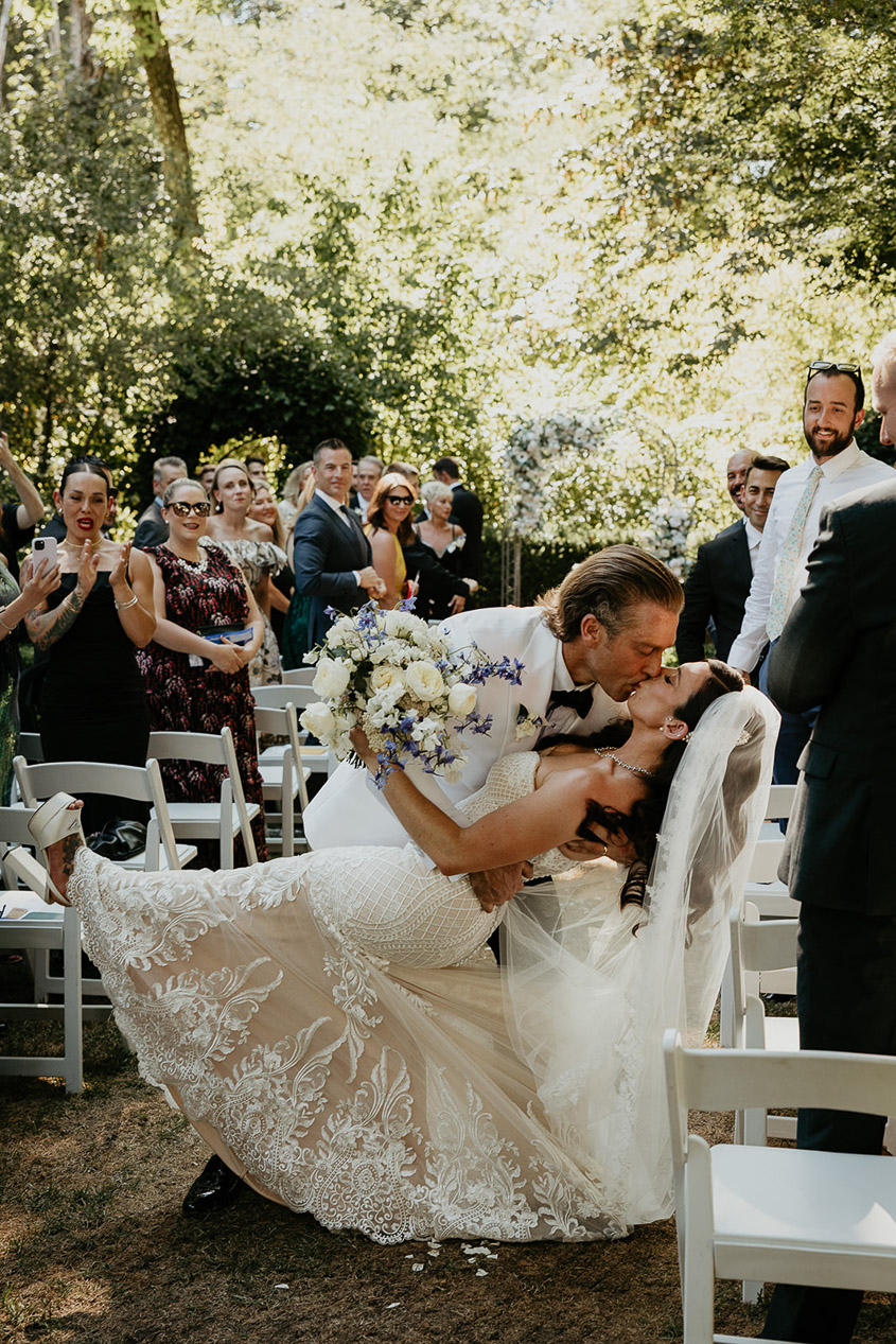 the bride and groom kissing at the end of their ceremony. 