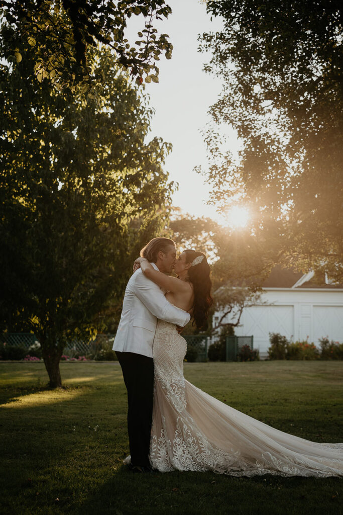 the newlyweds kissing outside of the mansion at Deepwood Museum and Gardens at sunset. 