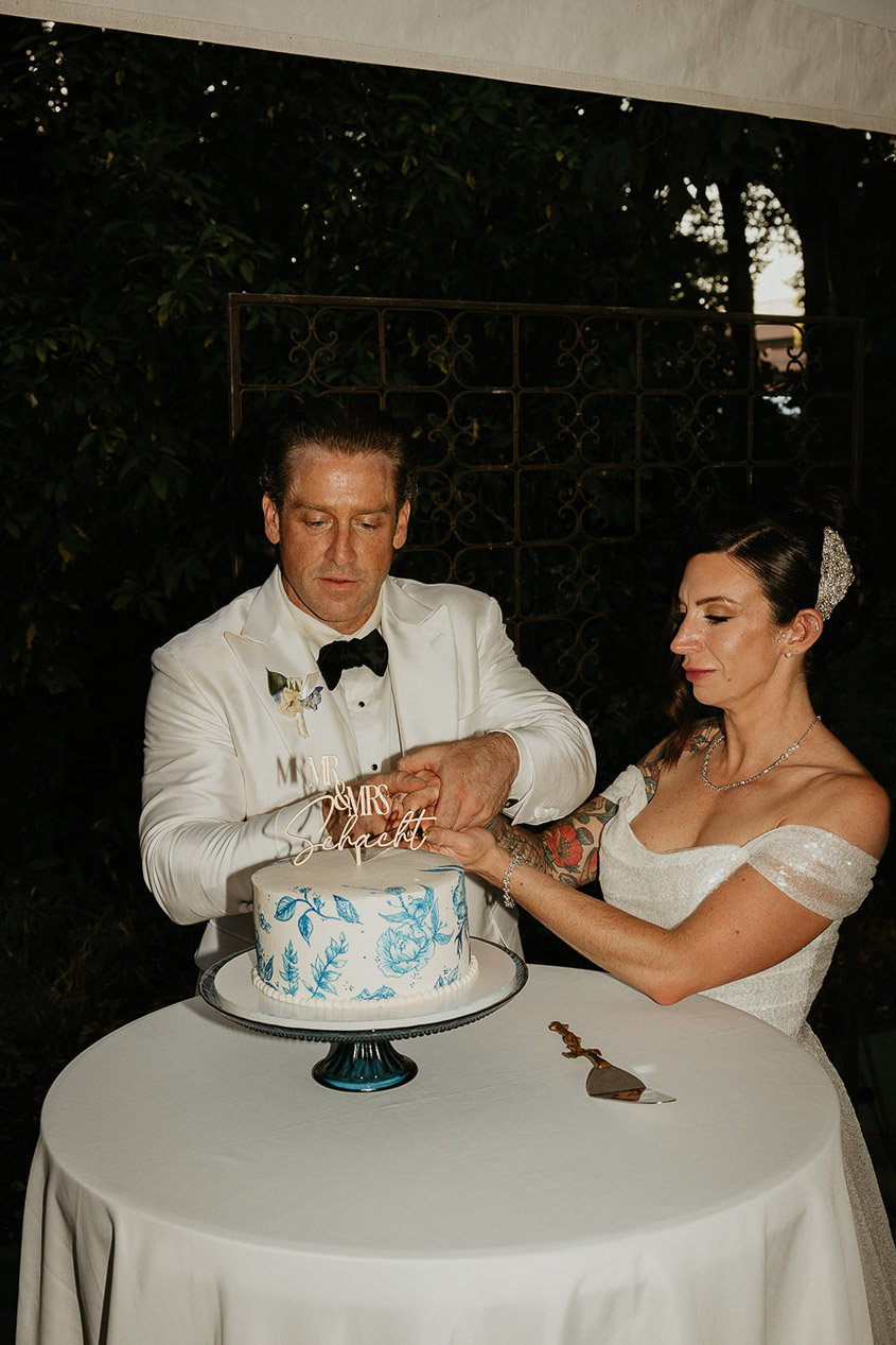 the bride and groom cutting their wedding cake. 