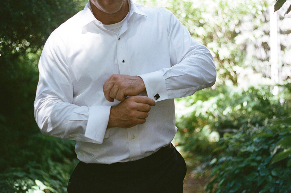 the groom adjusting his cufflinks. 