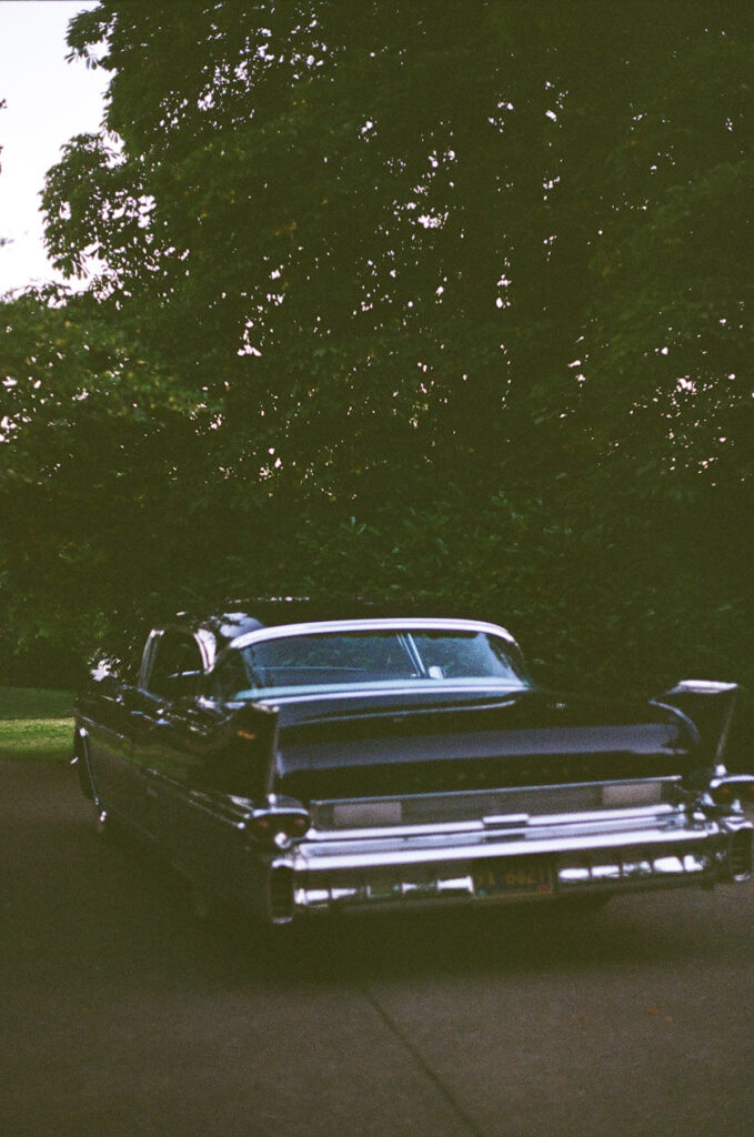 an old-timey car ready to take the newlyweds away. 