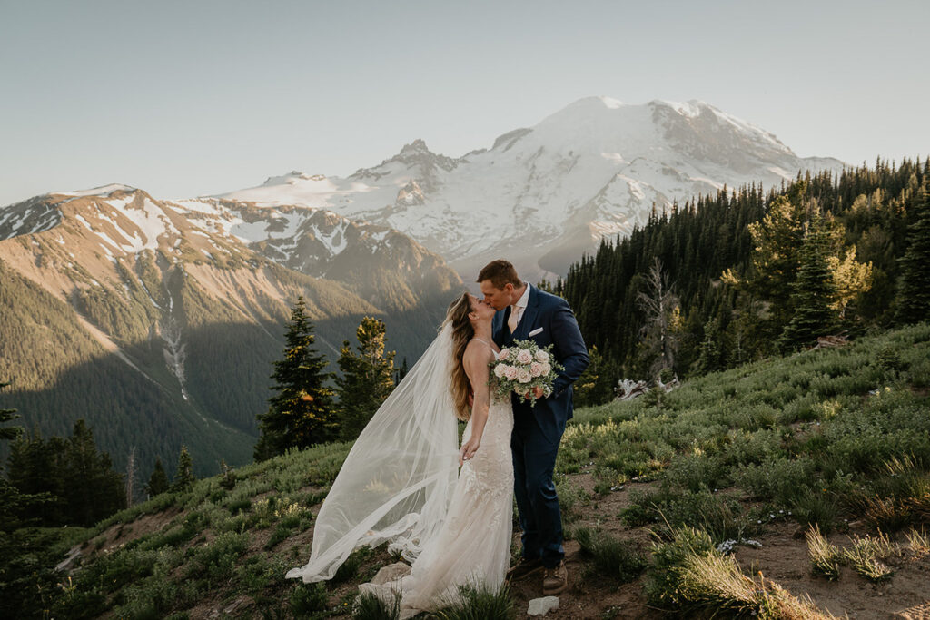 A couple kissing while they elope in Mt Rainier.