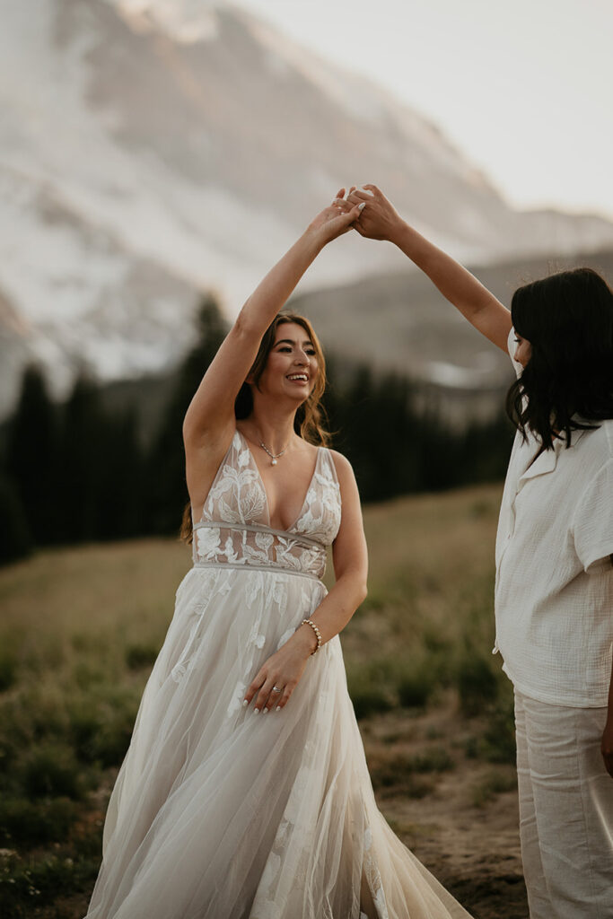 A couple dancing with Mt Rainier in the background. 