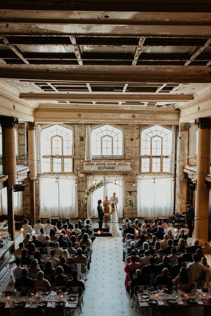 the bride and groom holding hands at the alter. 