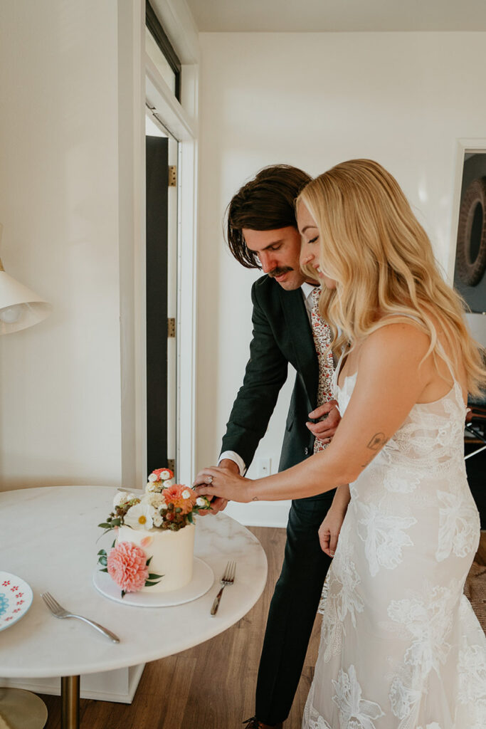 The newlyweds cutting their wedding cake. 