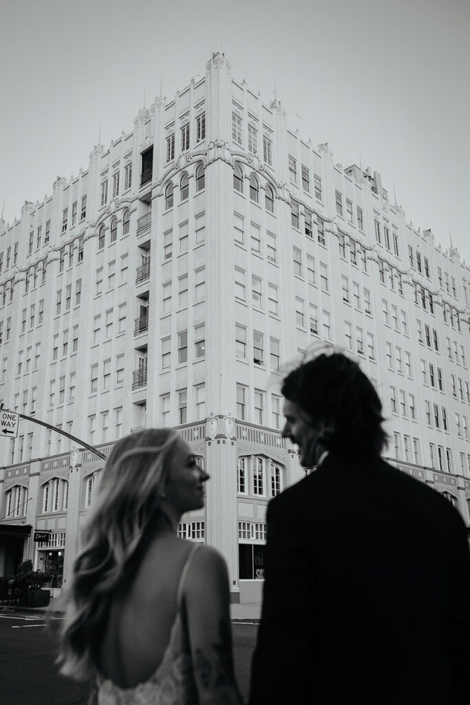 The newlyweds looking into each other's eyes and smiling. 