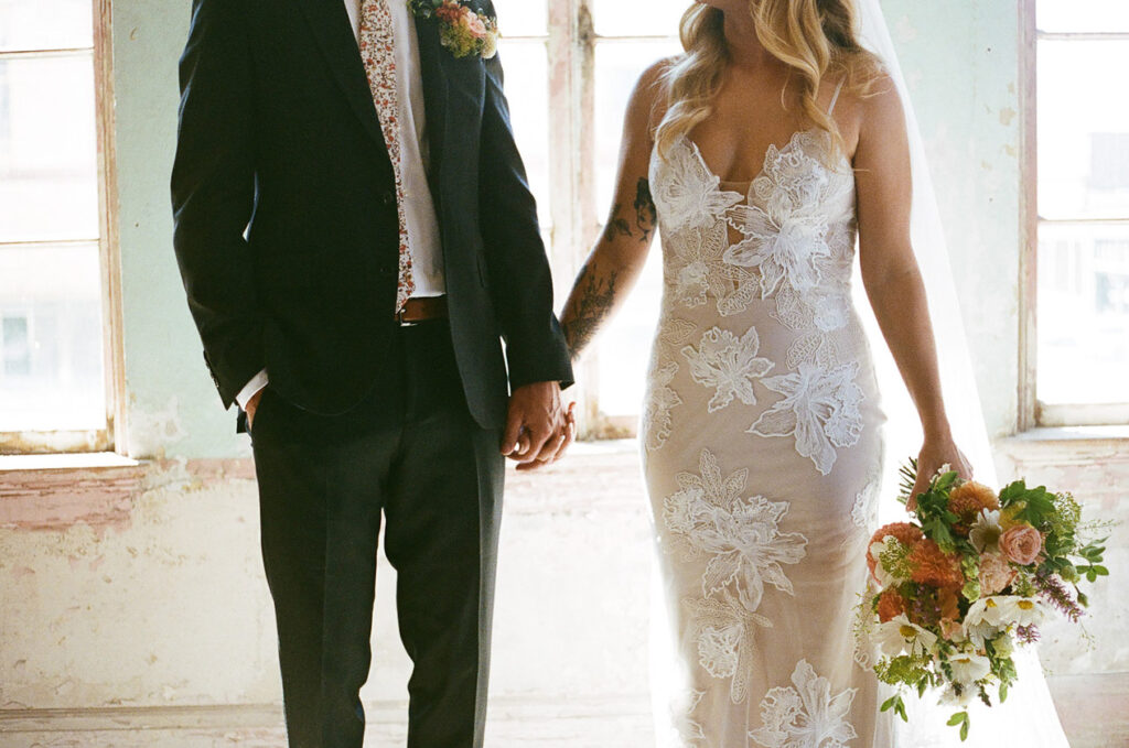 the newlyweds holding hands at The Ruins at the Astor. 