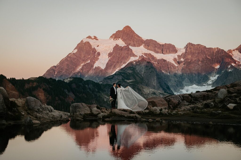 Bride lifts her veil during adventure photos at her Artist Point elopement 