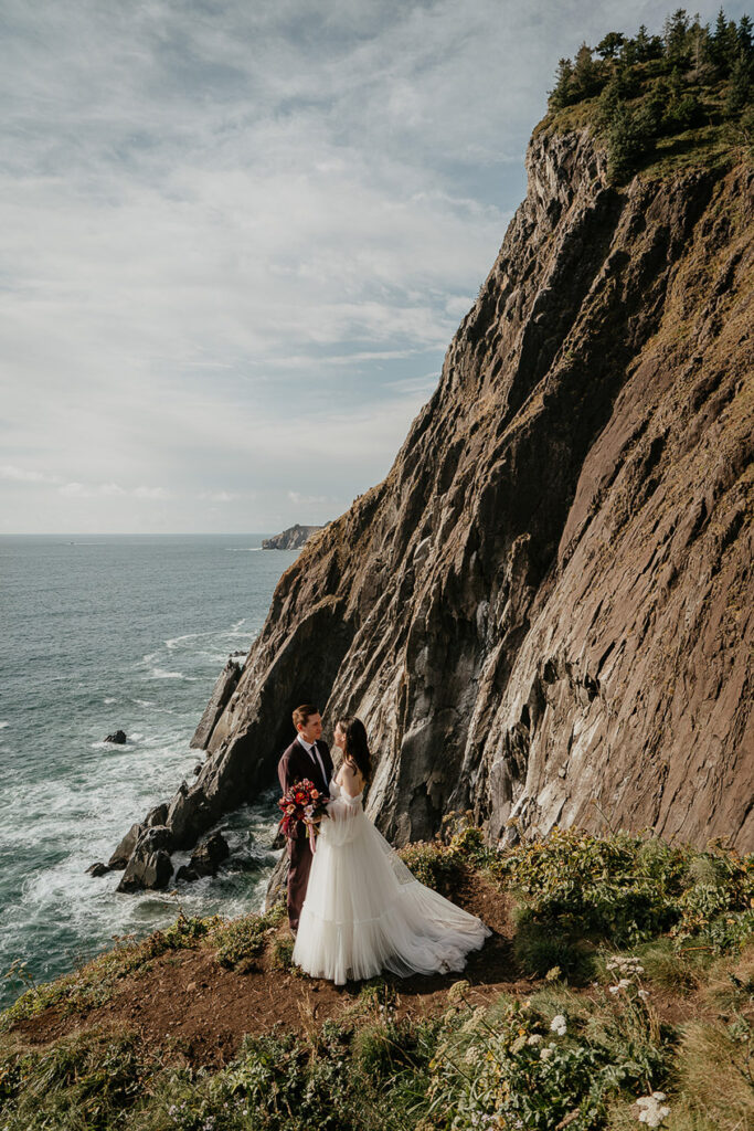 the newlyweds holding each other on the Oregon coast. 