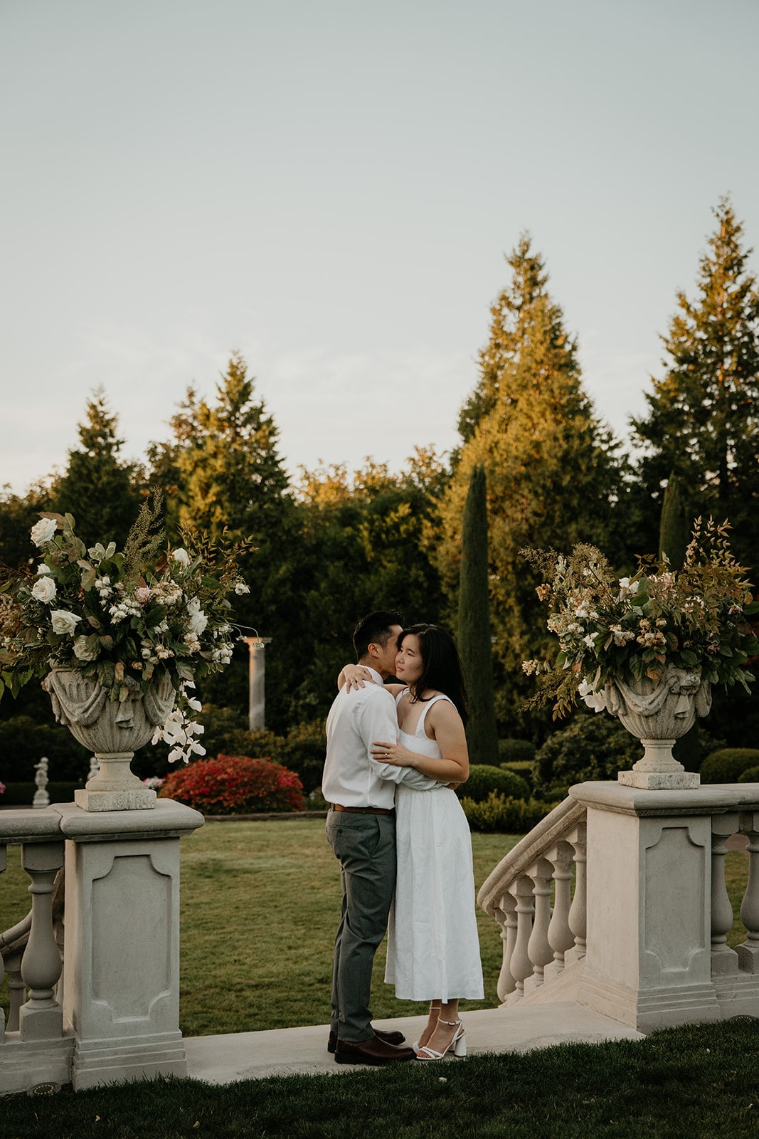 Couple slow dances on concrete steps at Chateau de Michellia during their Oregon engagement photo session