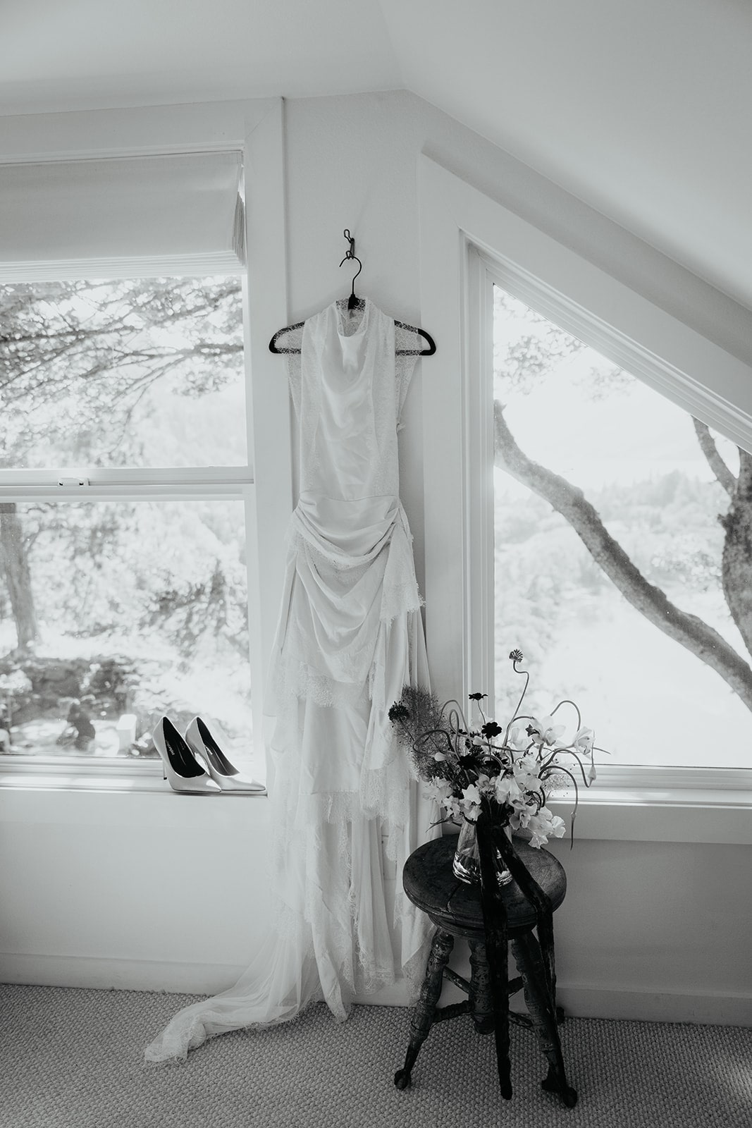 White wedding dress hanging from a hook at the Griffin House wedding venue in Oregon