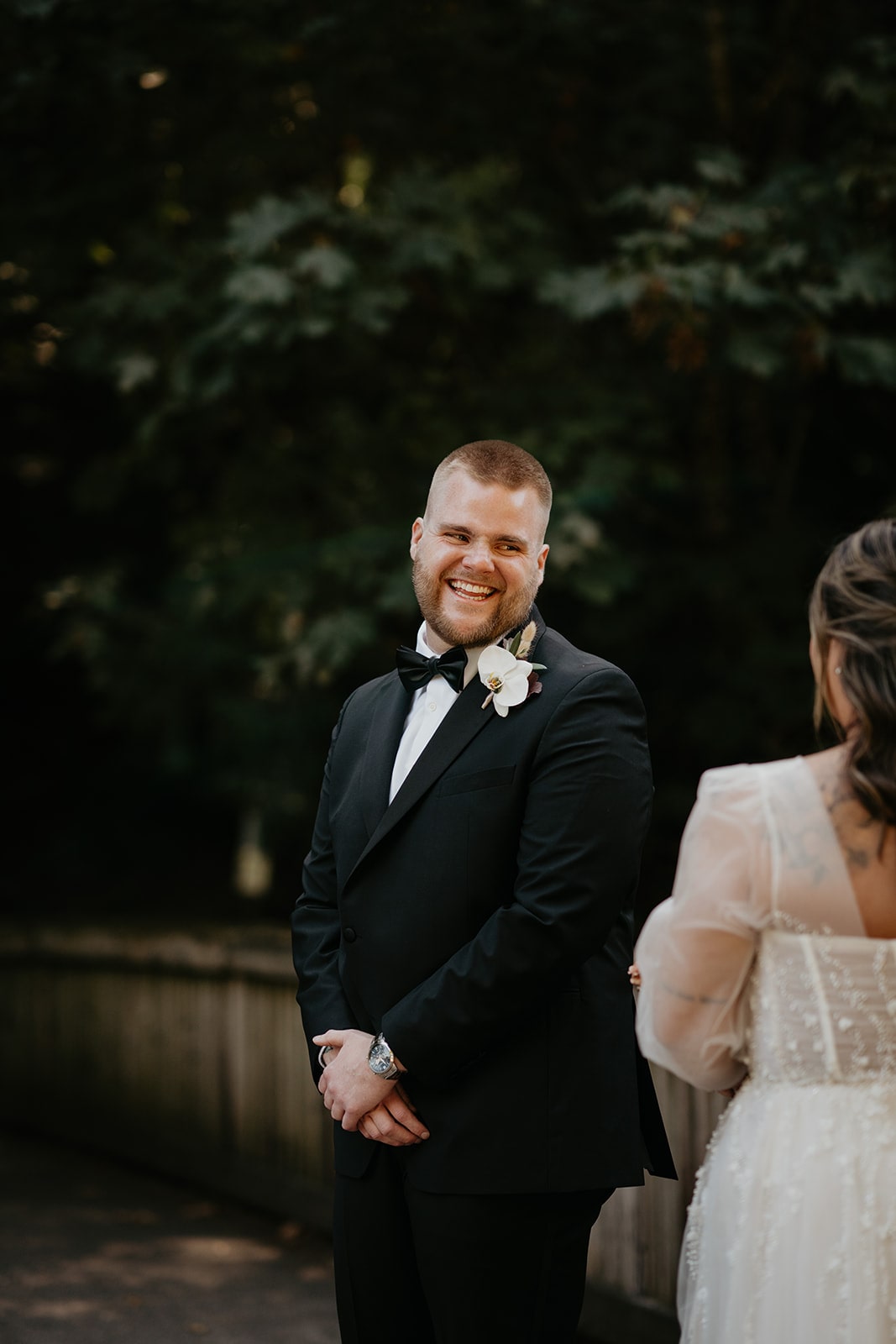 Groom smiles as he turns around for the first look with his bride