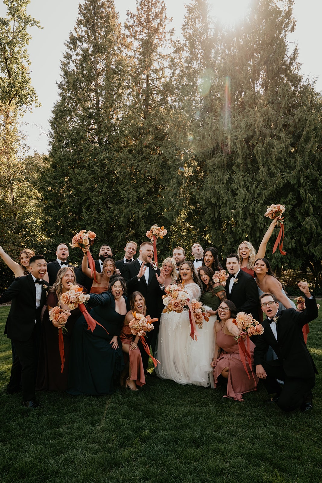 Wedding party cheers with bride and groom during their Ironlight Lake Oswego portrait photos 