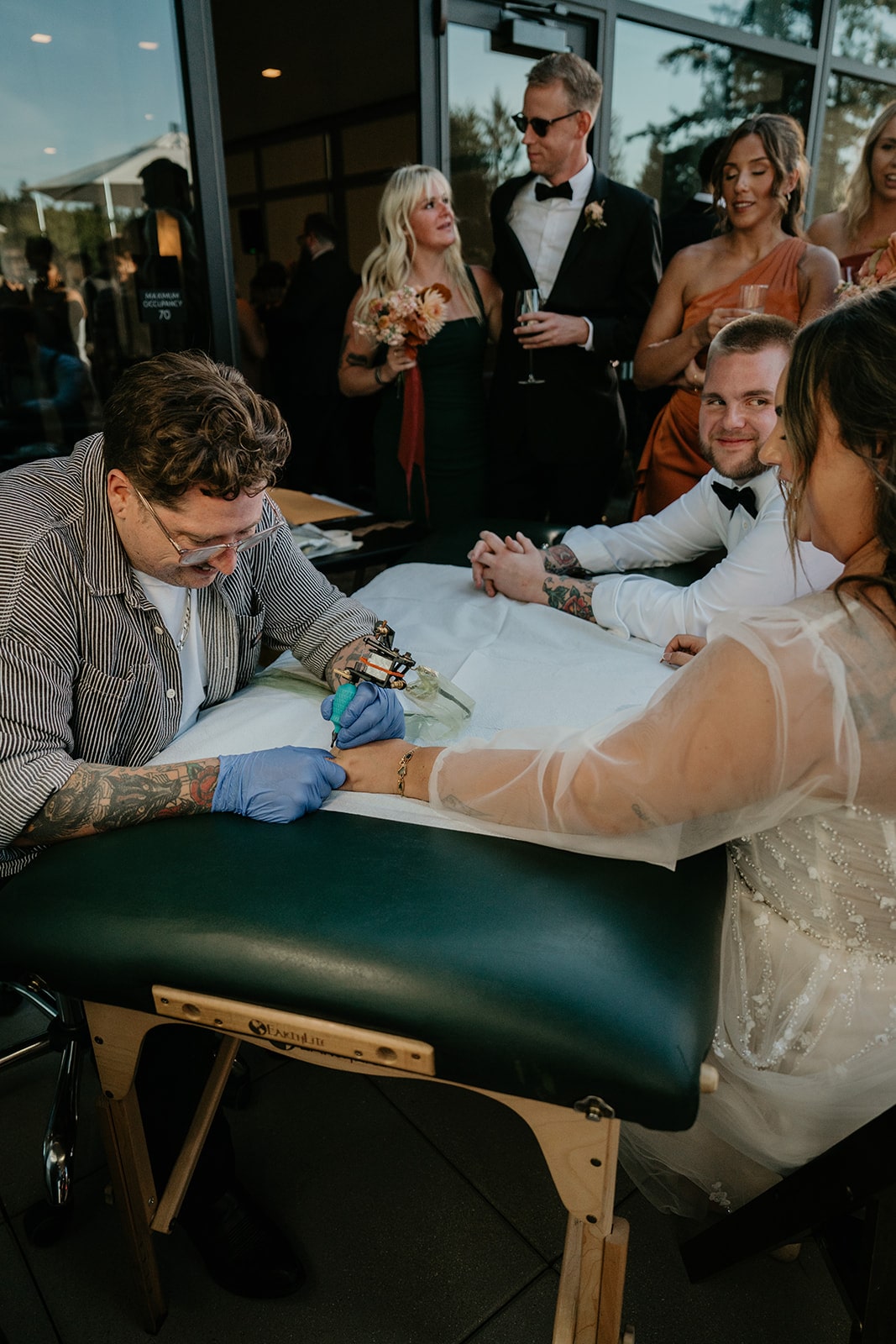 Bride gets tattooed at her Ironlight wedding reception in Oregon