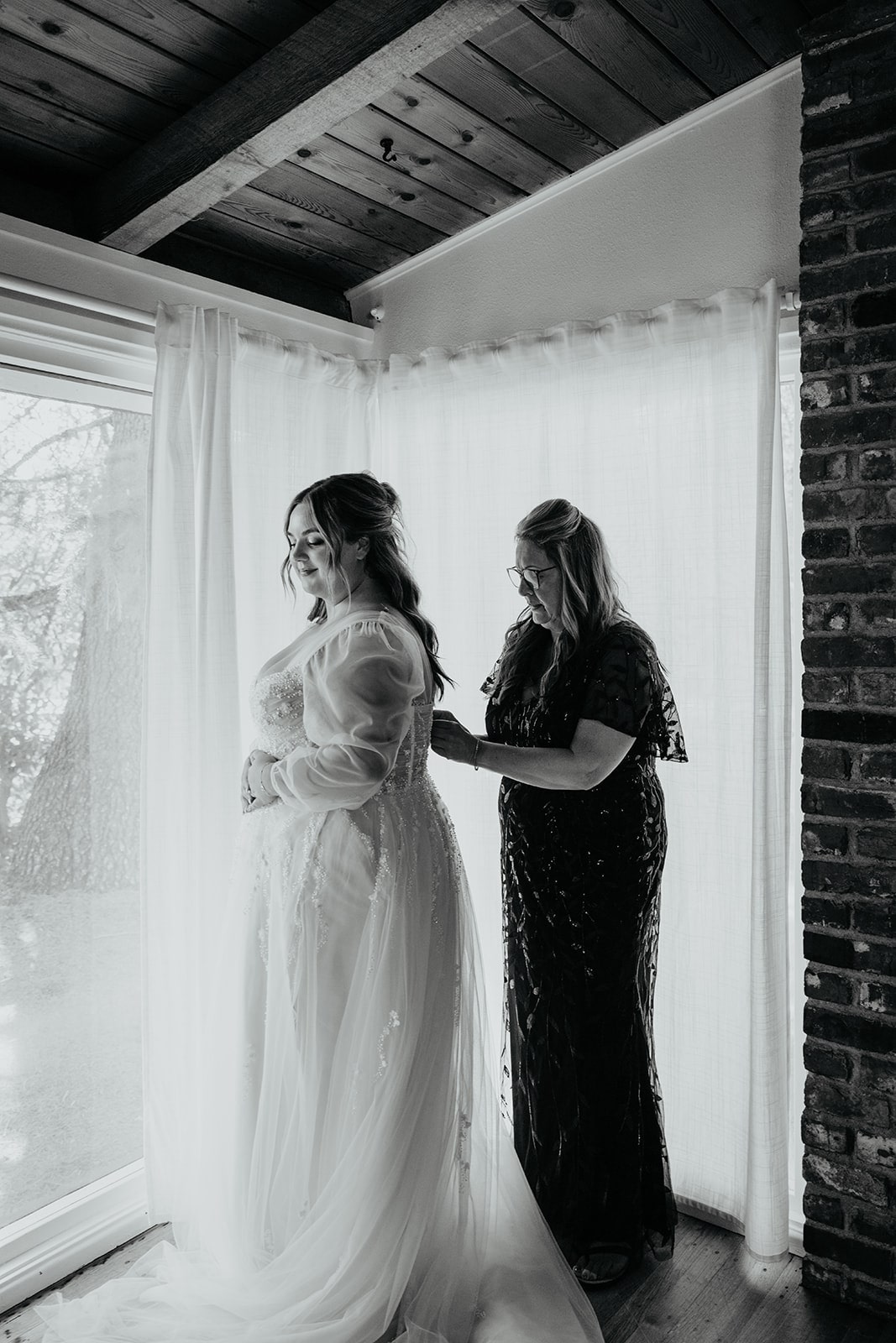 Bride's mother helps her into her white wedding dress at her Ironlight wedding in Lake Oswego