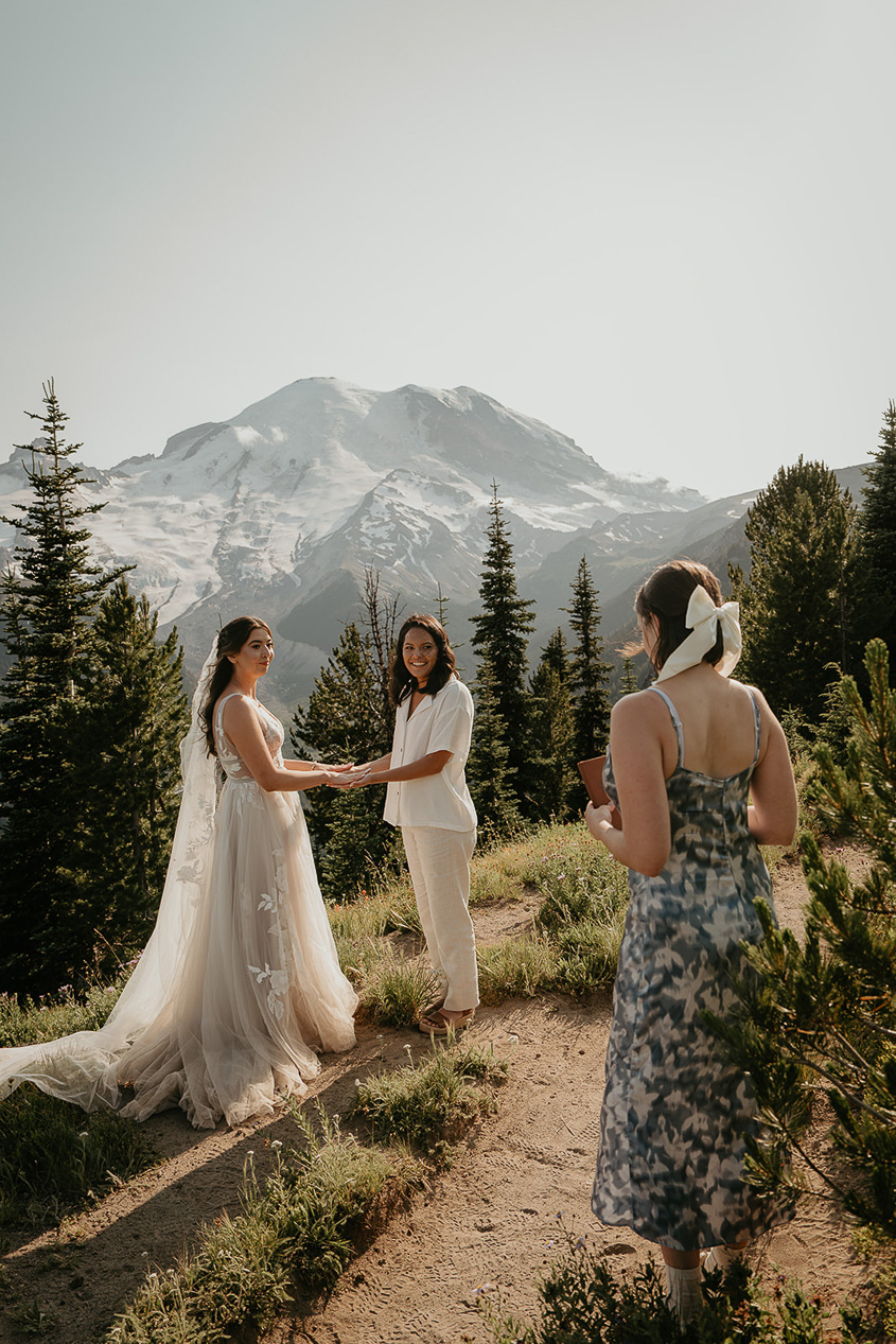 a couple getting married on a mountain, sweetened by how much more inexpensive the cost for them to elope versus have a traditional wedding is.
