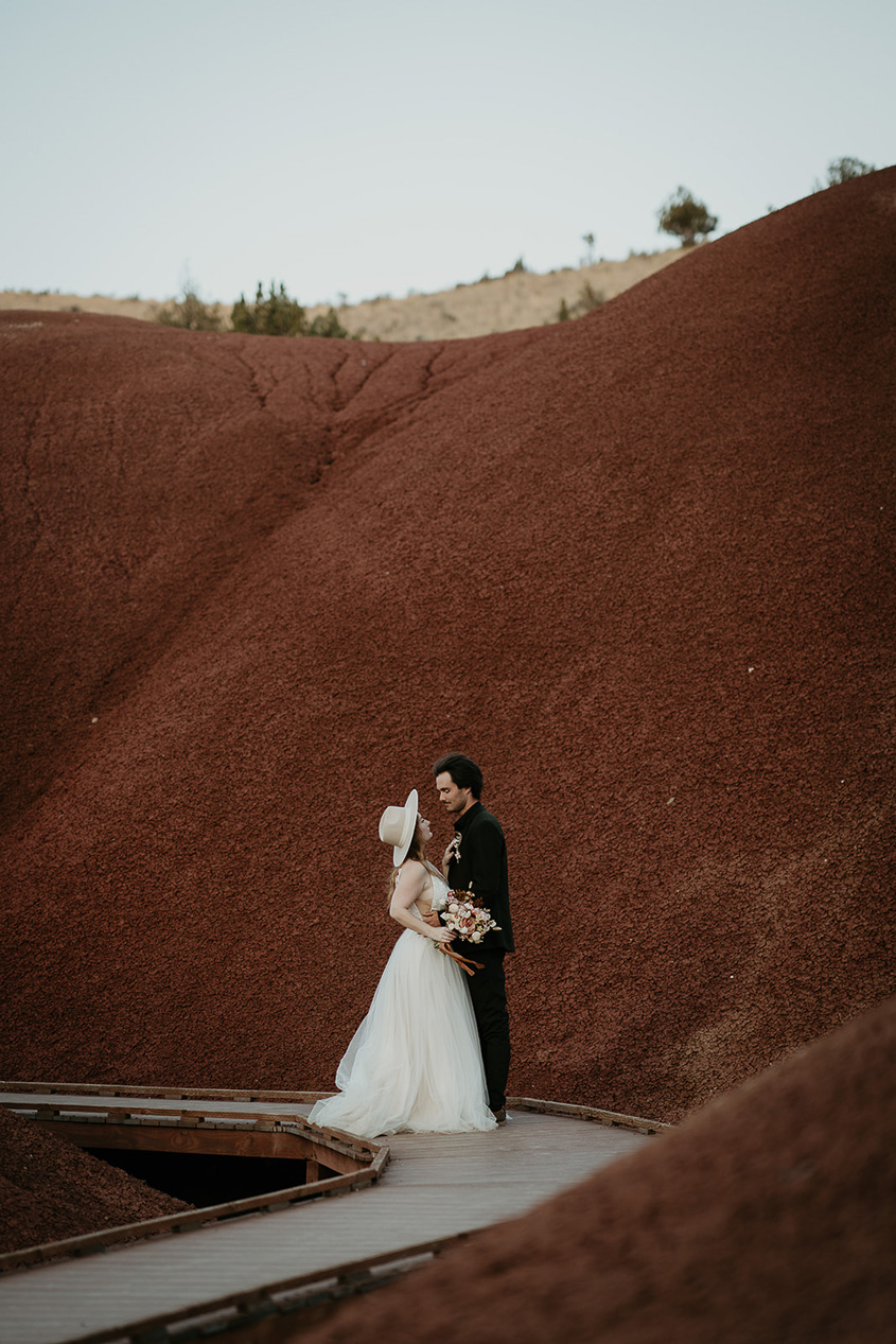 the newlyweds looking lovingly into each other's eyes during their painted hills elopement.