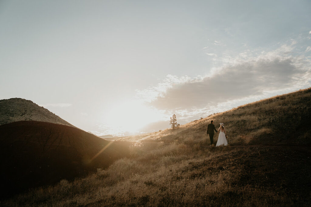 the newlyweds walking on a trail in the Oregon backcountry.