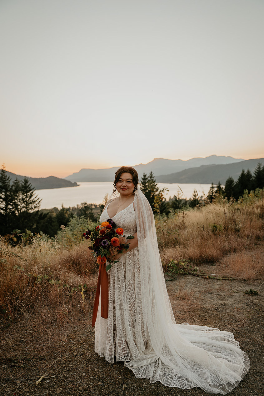 the bride posing at sunset during her wind mountain ranch wedding.