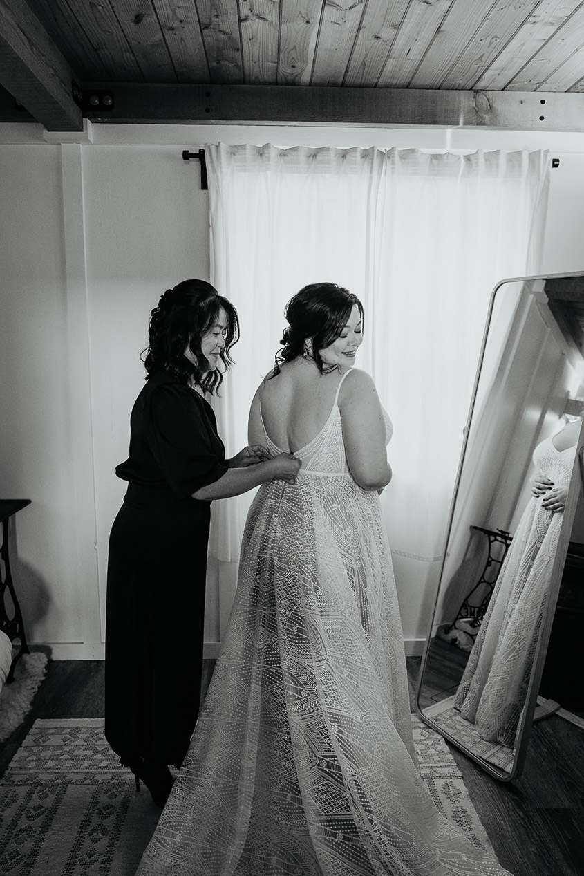 the bride getting her dress adjusted before her wedding.