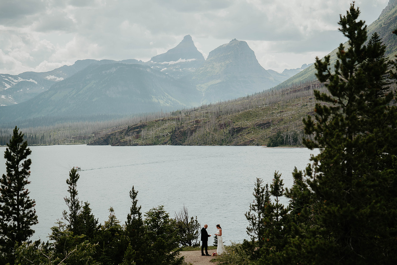 a couple exchanging vows in the mountains, a part of what an elopement ceremony can look like.