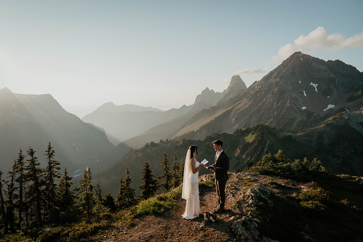 a couple exchanging vows in the mountain.