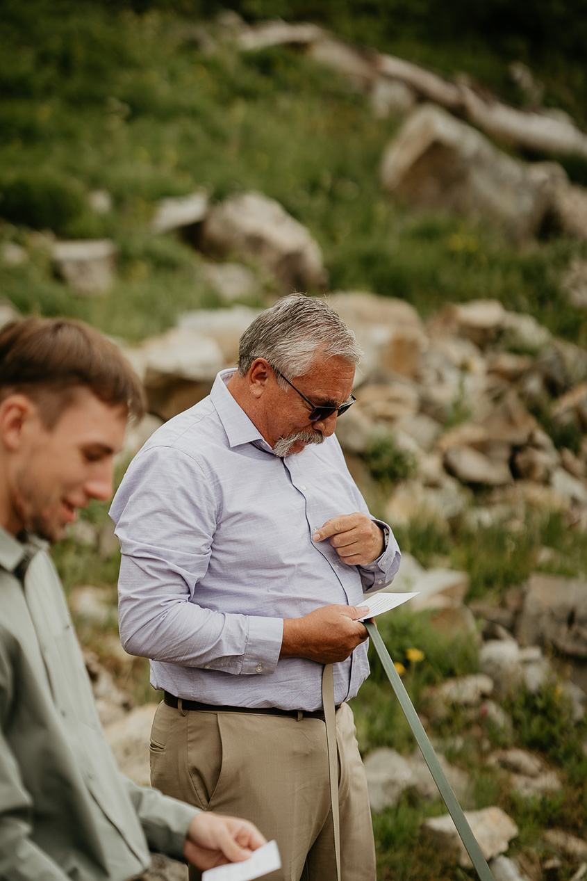 an elopement guest reading off of a note card during the ceremony.