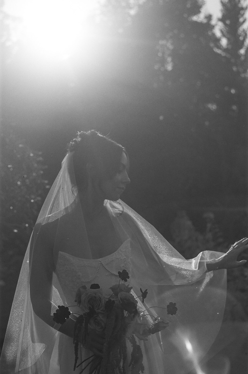 a bride posing in a garden during her Chateau de Michellia Wedding.