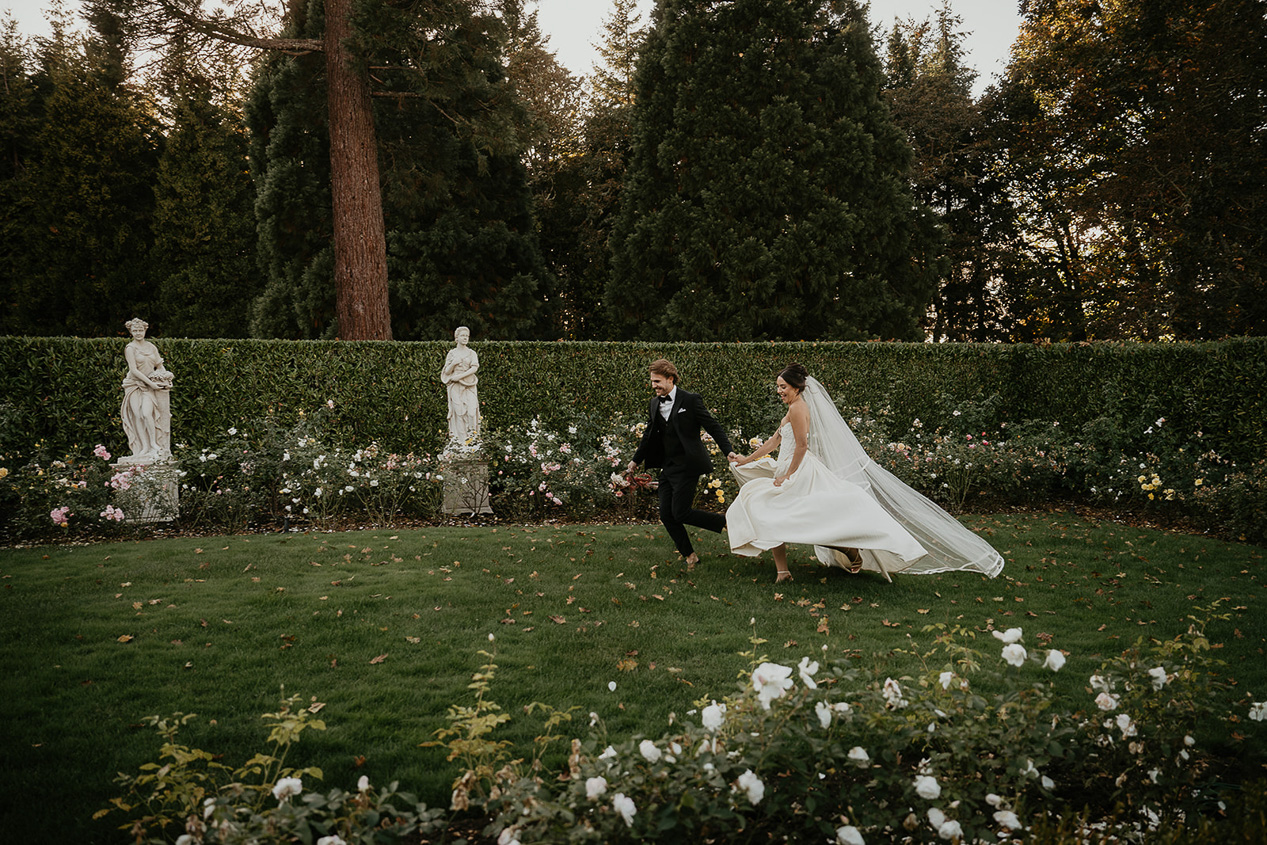 a couple running through a rose garden during their Chateau de Michellia Wedding