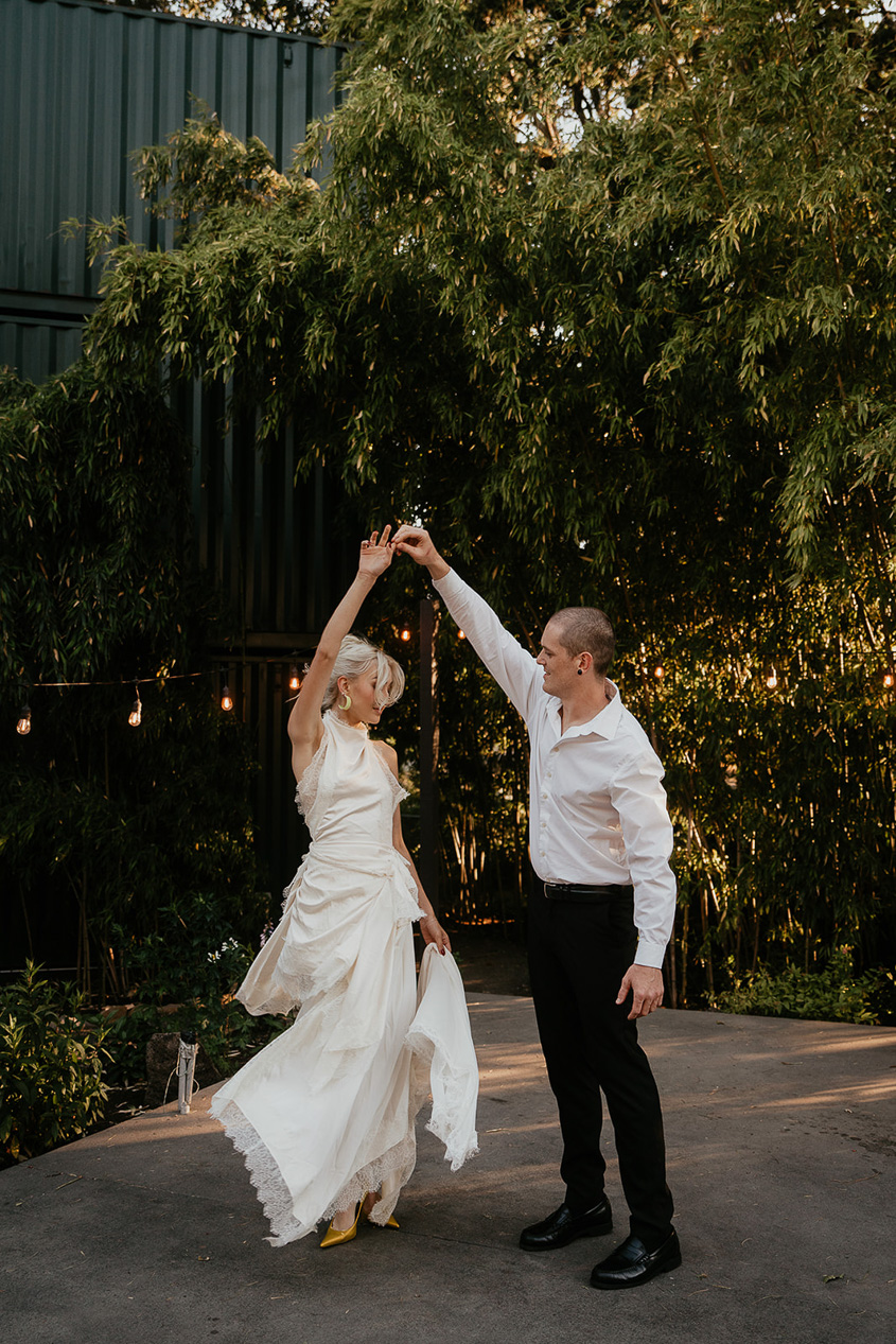 newlyweds dancing on The Griffin House patio, one of the best columbia river gorge wedding venues.
