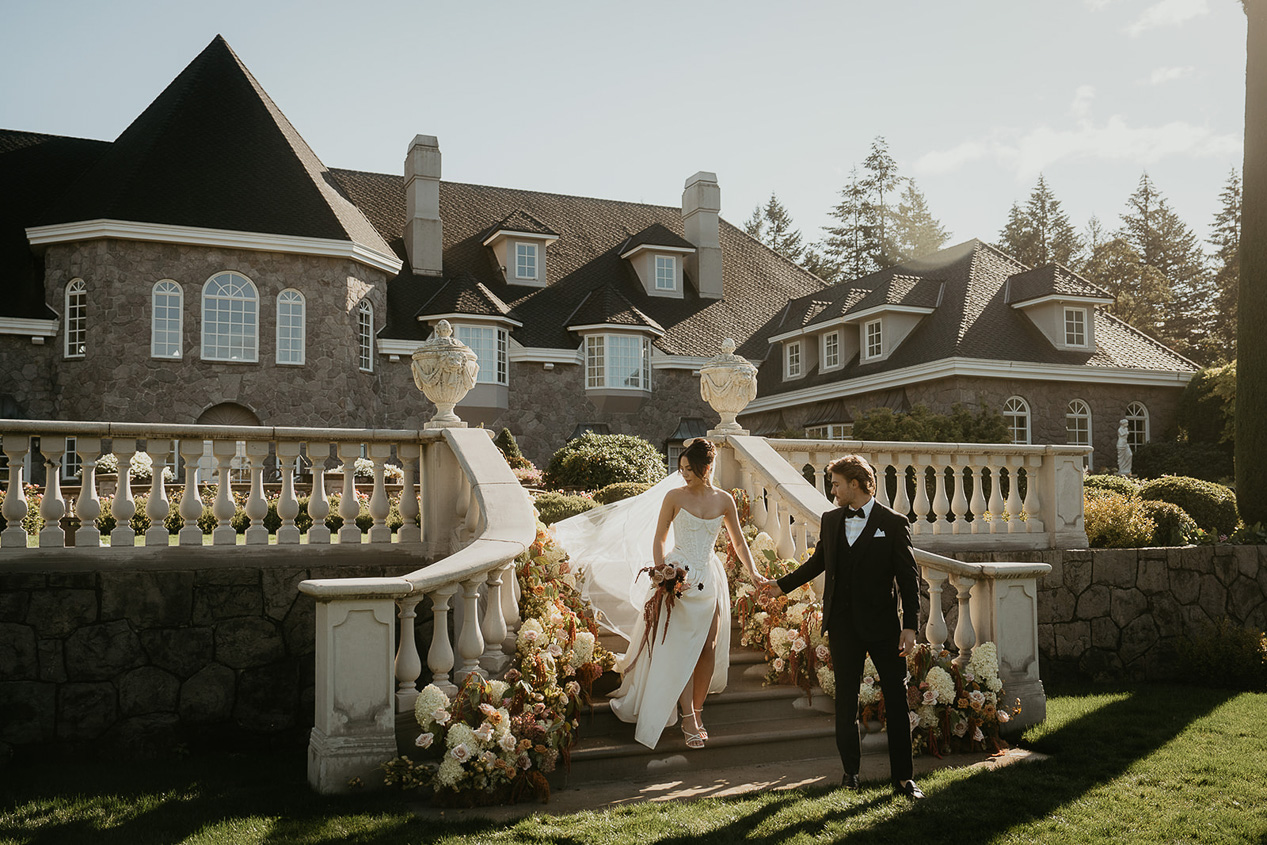 newlyweds holding hands exploring the grounds of the Chateau de Michellia.