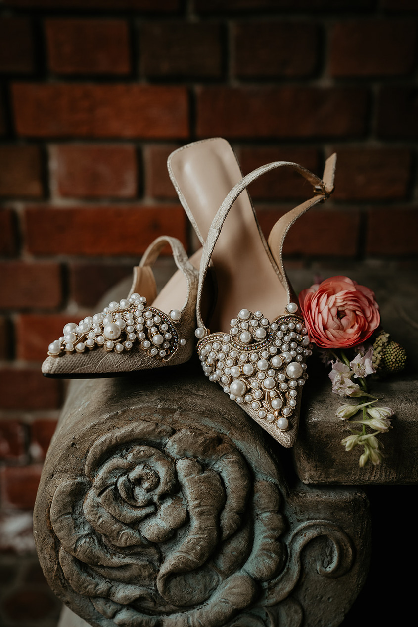 heels and a rose on a concrete rose.