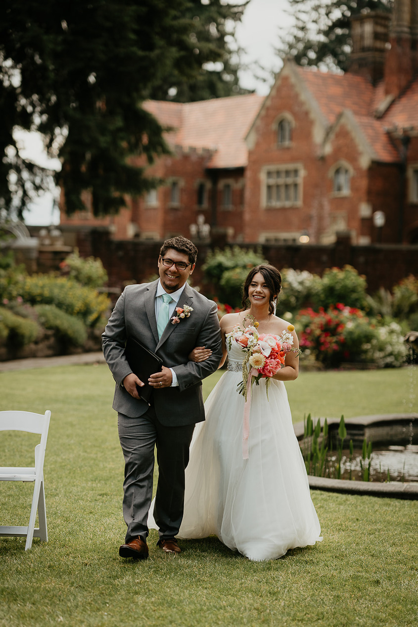 the bride walking down the isle of her thornewood castle wedding.
